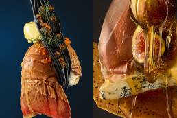 Close-up diptych of gourmet food: left panel shows lobster tail with dark pasta, rosemary, and a yellow sauce against a deep blue background; right panel features sliced ham, figs, crusty bread, and honey dripping over the cheese.